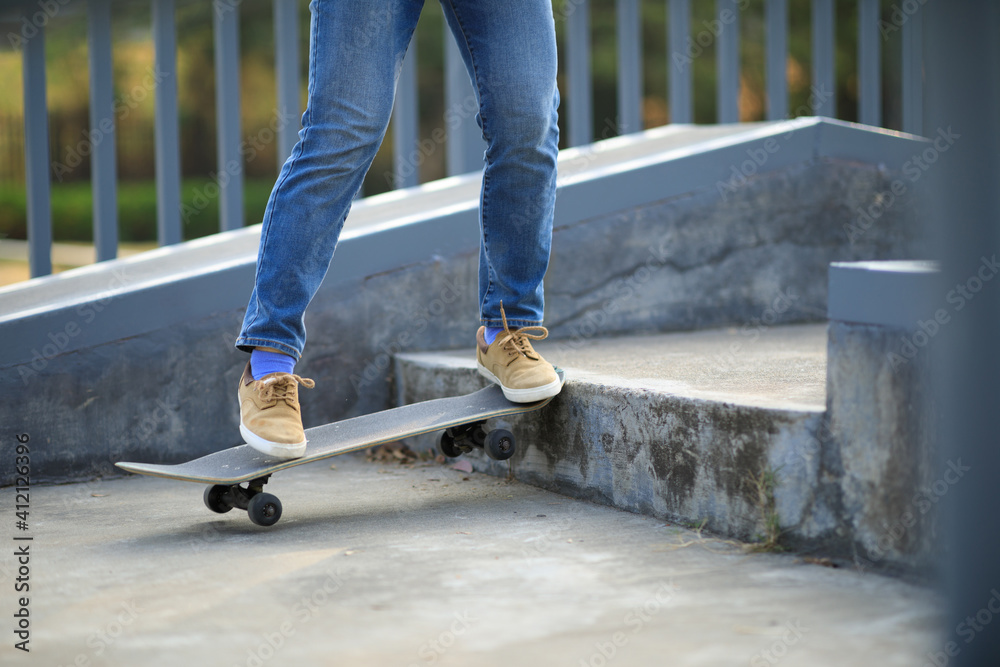 Asian woman skateboarder skateboarding at skatepark