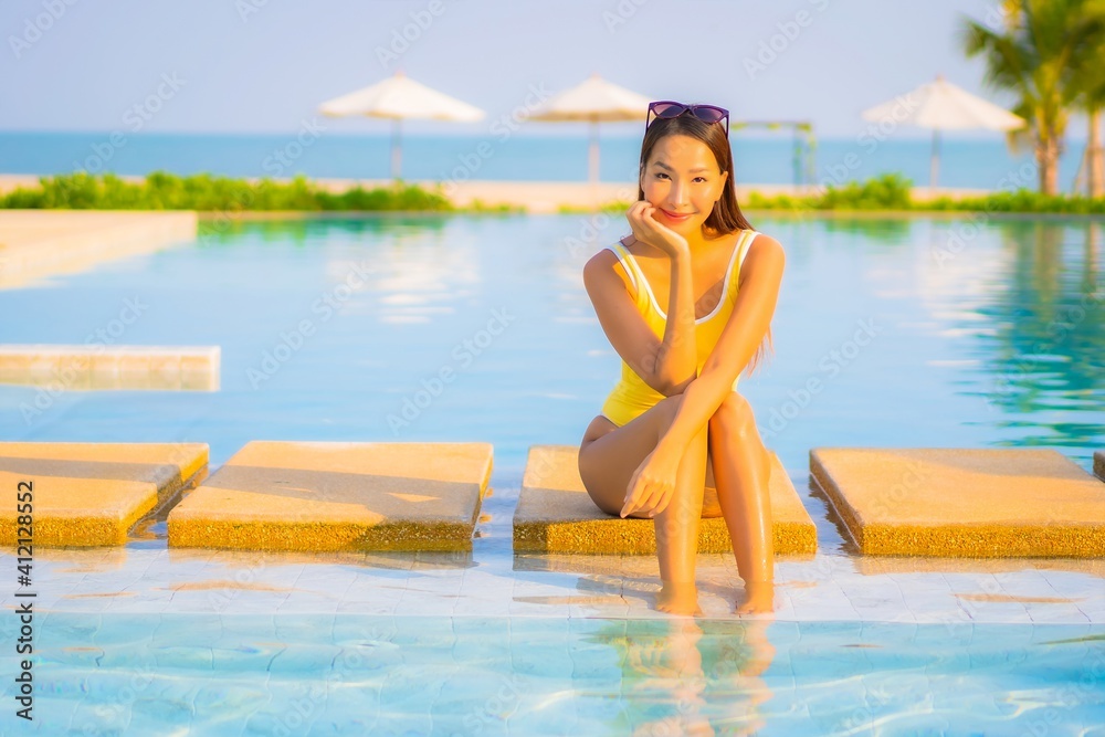 Portrait beautiful young asian woman relax smile enjoy leisure around swimming pool