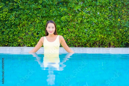 Portrait beautiful young asian woman relax smile enjoy leisure around swimming pool © siraphol