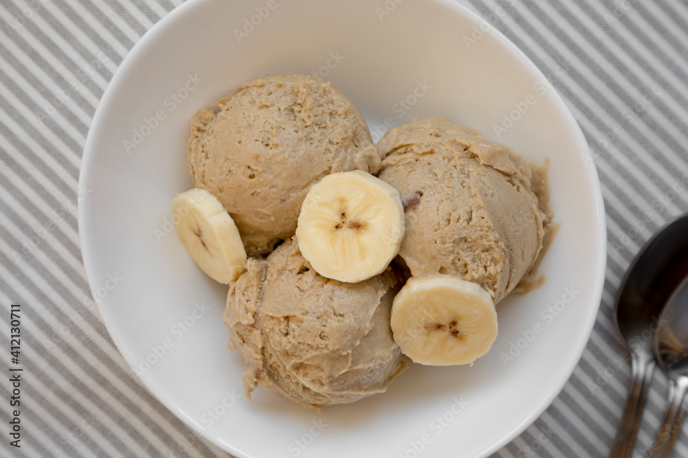 Homemade Peanut Butter Banana Ice Cream in a Bowl, top view. Flat lay, overhead, from above. Close-up. Homemade Peanut Butter Banana Ice Cream in a Bowl, top view. Flat lay, overhead, from above. Close-up.