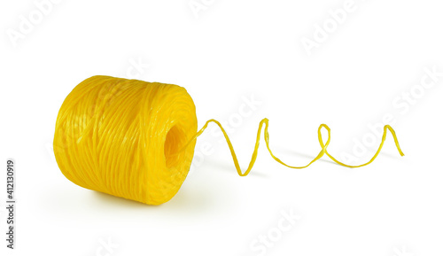 Εκτύπωση καμβά Yellow polypropylene twine unwound spool isolated on white background