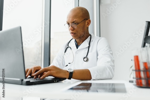 African American man male hospital doctor in white coat with stethoscope