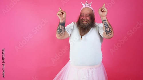 Funny man dancing and having fun while wearing a ballerina costume photo