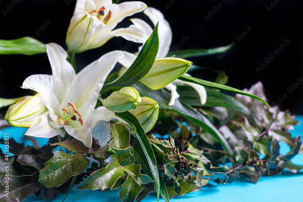 A bouquet of lilies on a light background. Mother's Day, Women's Day, Valentine's Day or Birthday. A bouquet of lilies on a light background. Mother's Day, Women's Day, Valentine's Day or Birthday.