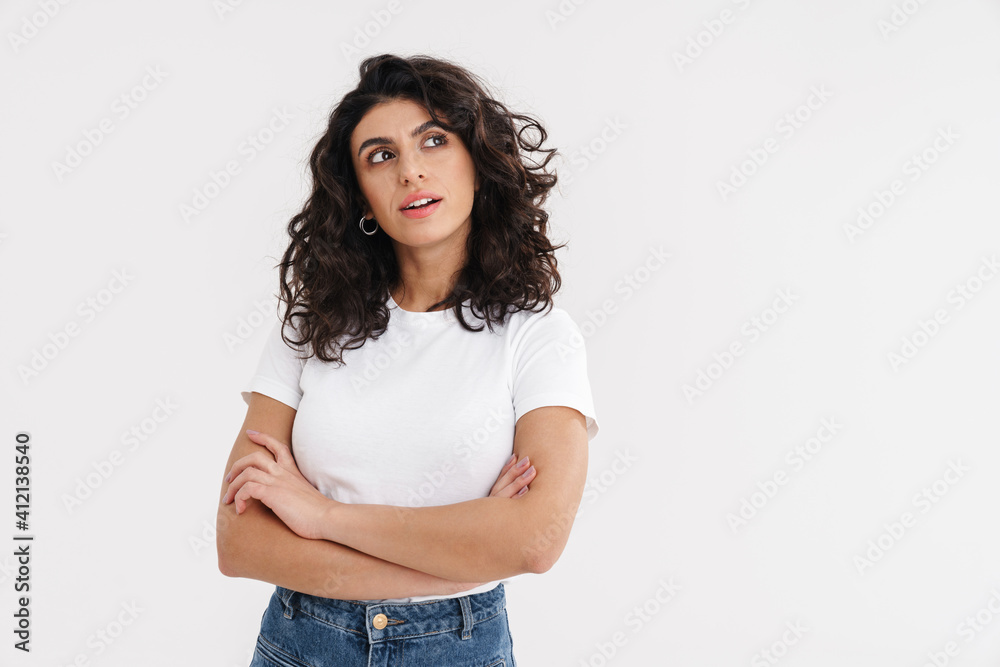 Thinking beautiful brunette girl posing with arms crossed Thinking beautiful brunette girl posing with arms crossed