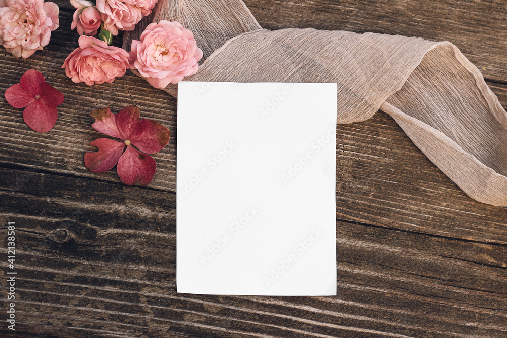 Summer wedding still life scene. Blank greeting card mock-up. Floral composition with pink roses, hydrangea flowers on old wooden table background with silk ribbon. Flat lay, top view. - obrazy, fototapety, plakaty 