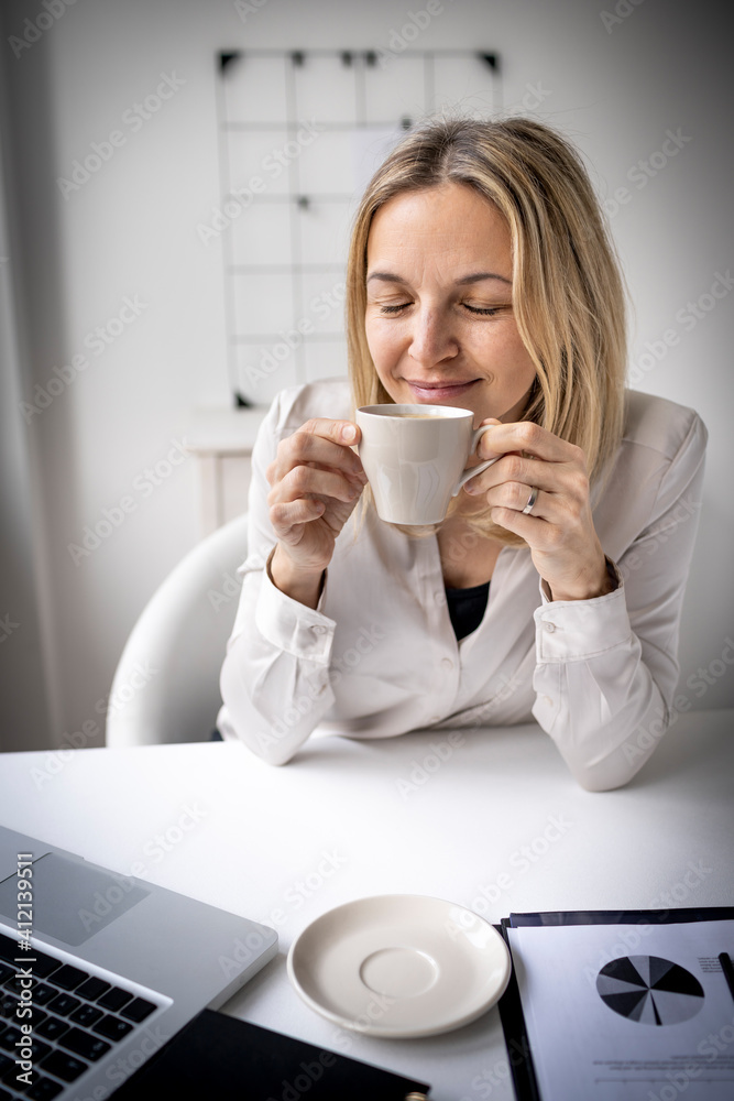 Business woman enjoy coffee break while working in 5office Business woman enjoy coffee break while working in 5office