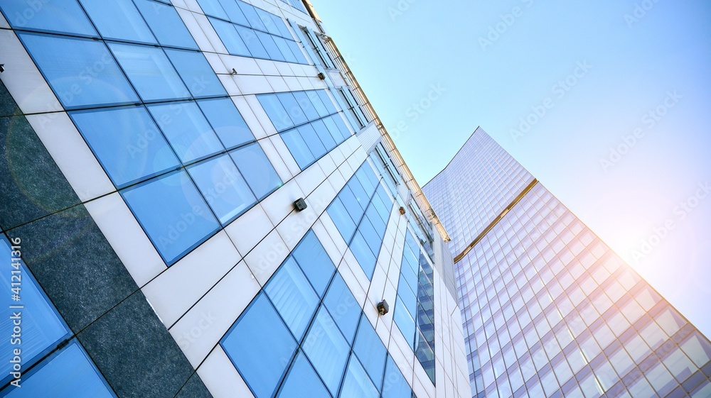 Downtown corporate business district architecture. Glass reflective office buildings against blue sky and sun light. Economy, finances, business activity concept.