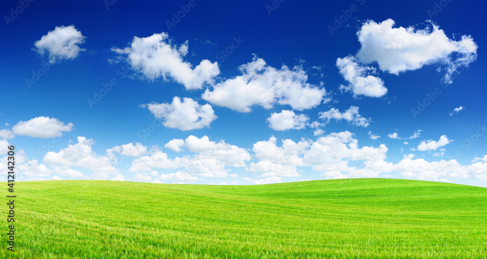Idyllic view, green hills and blue sky with white clouds Idyllic view, green hills and blue sky with white clouds