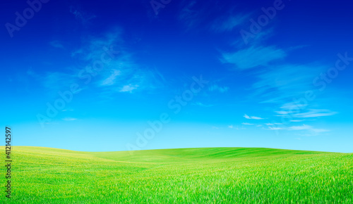 Idyllic view, green hills and blue sky with white clouds