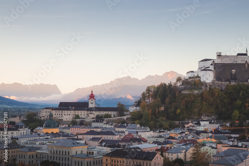 Sunrise or sunset cityscape view of Stift Nonnberg Benedictine Monastery, Fortress Hohensalzburg and the city of Salzburg, Austria with the Eastern Bavarian Alps. photo