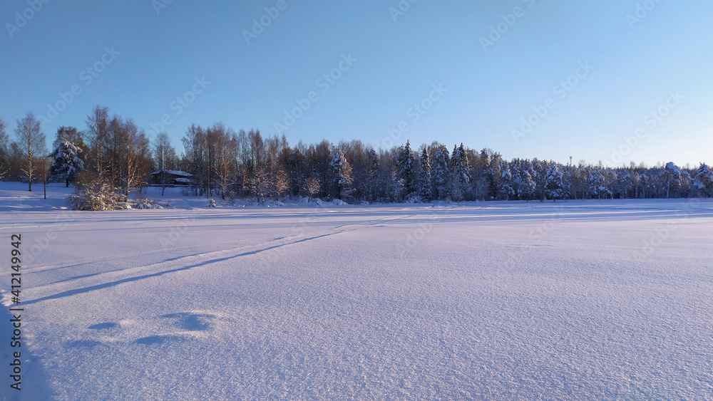 A frosty sunny day on a snow-covered lake. A frosty sunny day on a snow-covered lake.