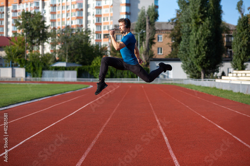 Athletic man jumping outdoor during workout