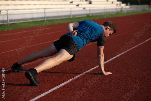Athletic enduring man doing exercises