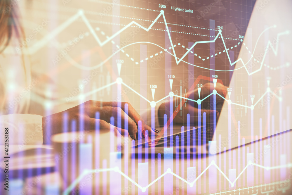 Double exposure of woman hands working on computer and forex graph hologram drawing. Financial analysis concept.