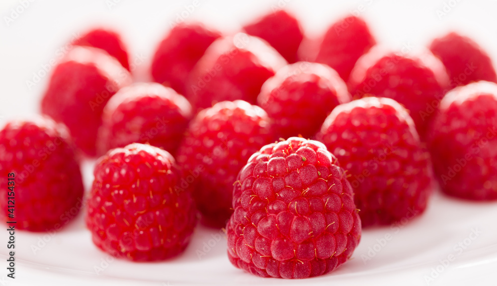handful of raspberry berries on white background handful of raspberry berries on white background