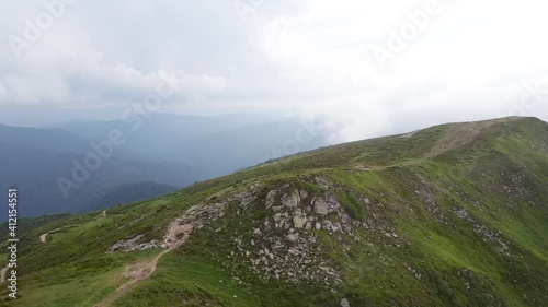 aerial view of green mountains  on a background of blue sky
