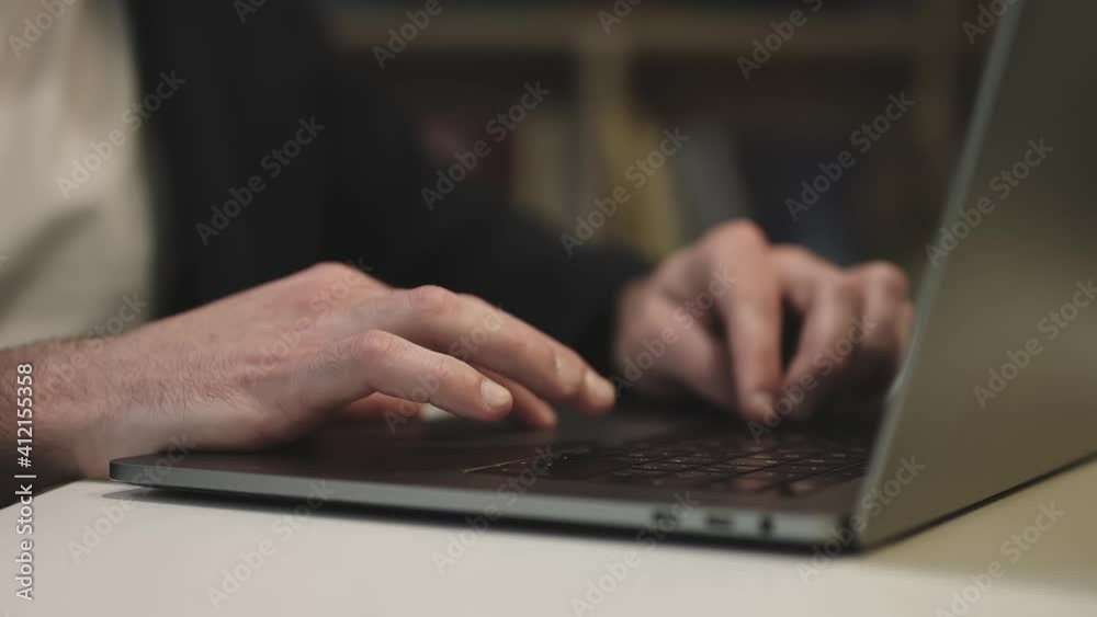 Close-up of the keyboard. Businessman working on a laptop.