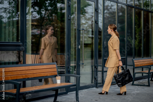 Business Women Style. Woman with Briefcase Going To Work. Portrait Of Beautiful Smiling Female In Stylish Office Clothes. High Resolution.