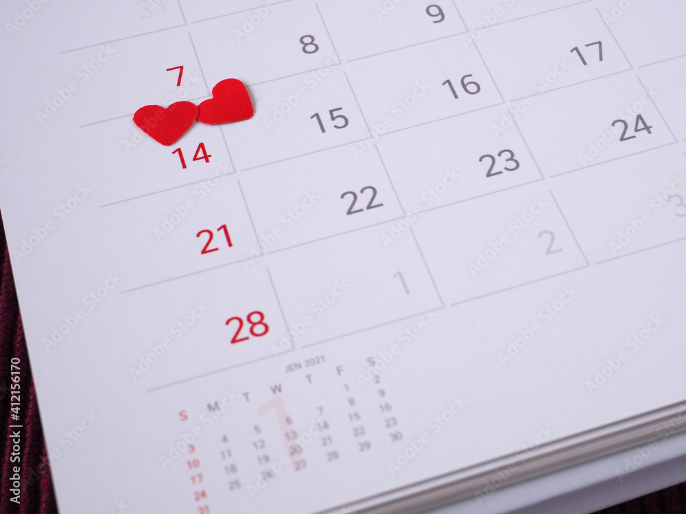 Red heart on the 14th day of the calendar page. Close up, with copy space for your text. Concepts Valentine's Day, anniversary, and wedding.. Red heart on the 14th day of the calendar page. Close up, with copy space for your text. Concepts Valentine's Day, anniversary, and wedding..