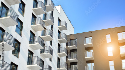 Modern apartment buildings on a sunny day with a blue sky. Facade of a modern apartment building.Glass surface with sunlight.
