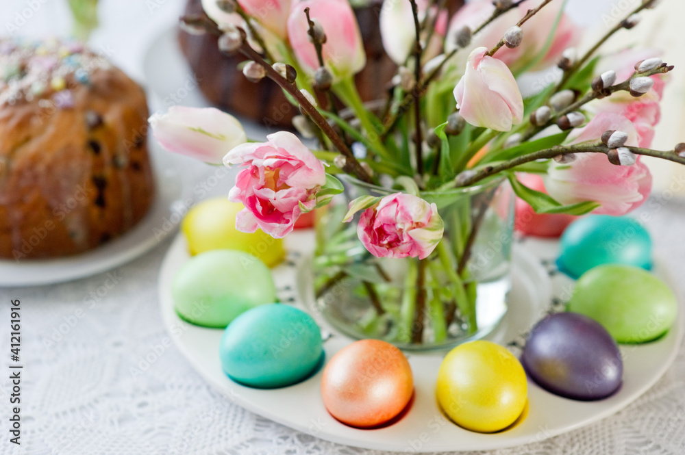 Easter still life with a bouquet of tulips and willow, Easter eggs and cake in pastel colors Easter still life with a bouquet of tulips and willow, Easter eggs and cake in pastel colors