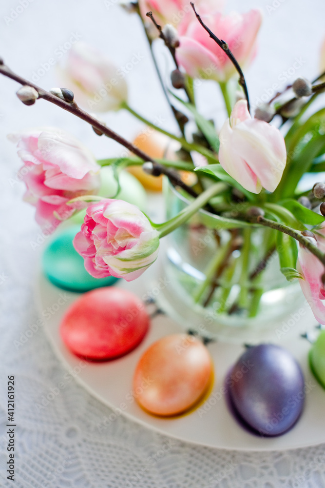 Easter still life with a bouquet of tulips and willow, Easter eggs and cake in pastel colors Easter still life with a bouquet of tulips and willow, Easter eggs and cake in pastel colors