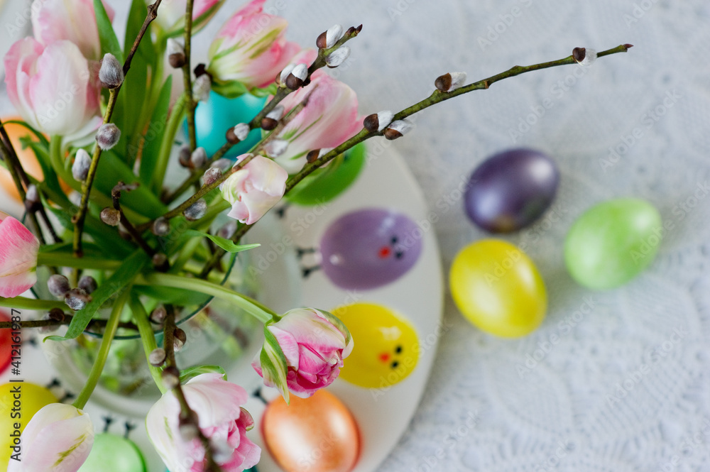 Easter still life with a bouquet of tulips and willow, Easter eggs and cake in pastel colors