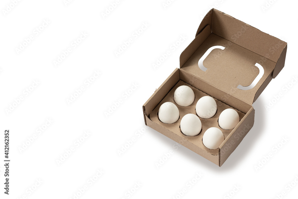 Close-up view of raw chicken eggs in egg box on white wooden background Close-up view of raw chicken eggs in egg box on white wooden background