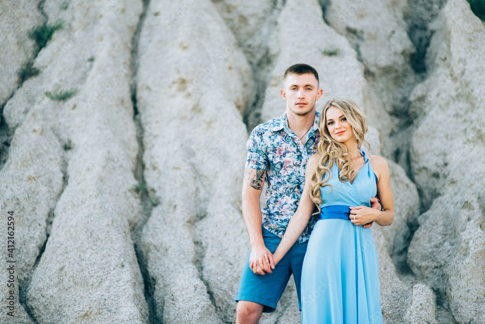 blonde girl in a light blue dress and a guy in a light shirt in a granite quarry blonde girl in a light blue dress and a guy in a light shirt in a granite quarry
