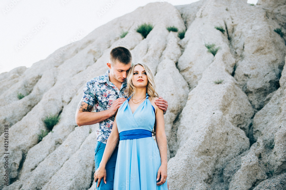 blonde girl in a light blue dress and a guy in a light shirt in a granite quarry blonde girl in a light blue dress and a guy in a light shirt in a granite quarry