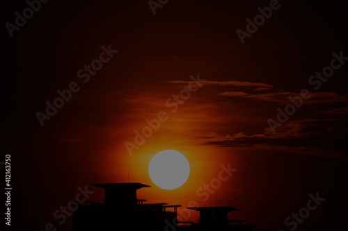 sunset behind building