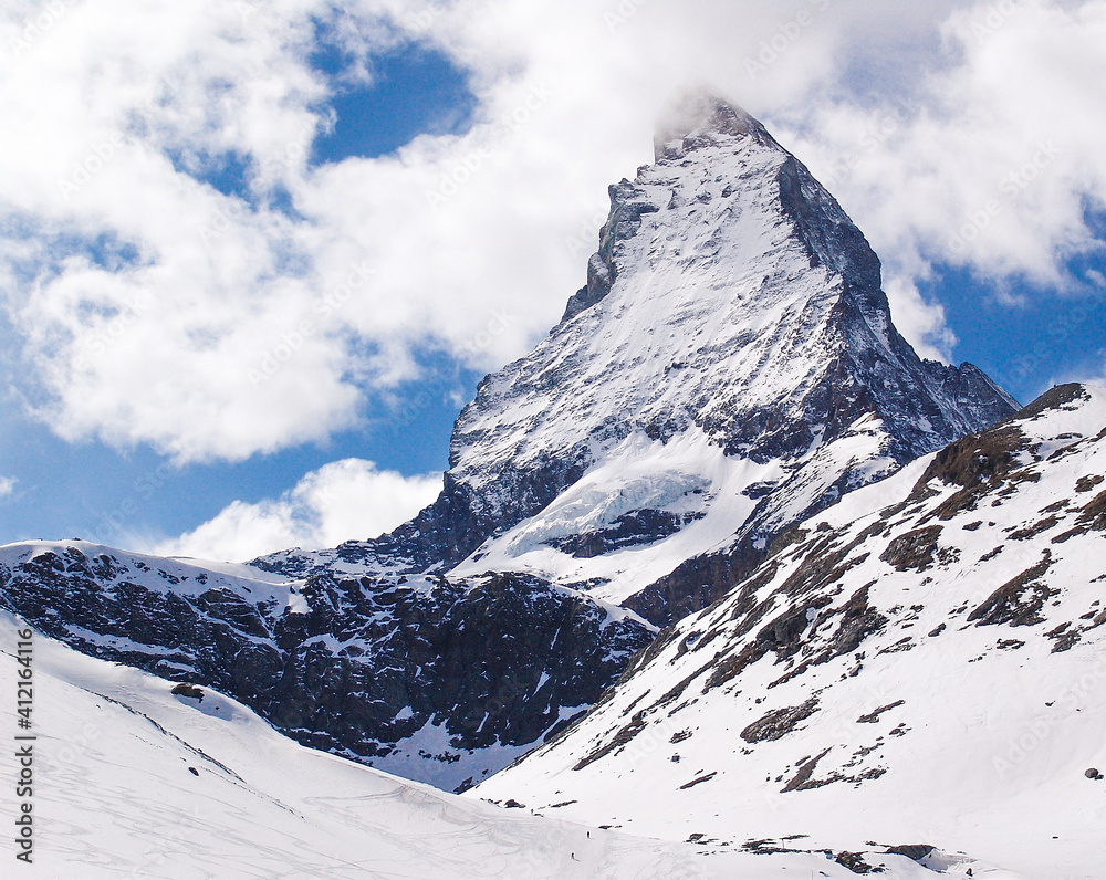 The immaculate peak of the Matterhorn rises above the village of Zermatt in the Swiss Alps. Thousands of mountaineers, skiers and tourists admire it every day.