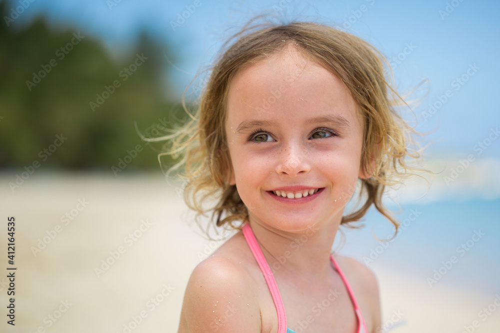 Portrait of adorable little girl at beach during summer vacation