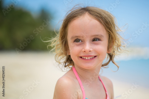 Portrait of adorable little girl at beach during summer vacation © Artem Zakharov