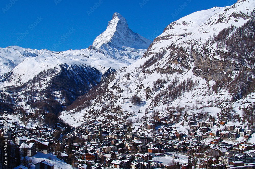 The immaculate peak of the Matterhorn rises above the village of