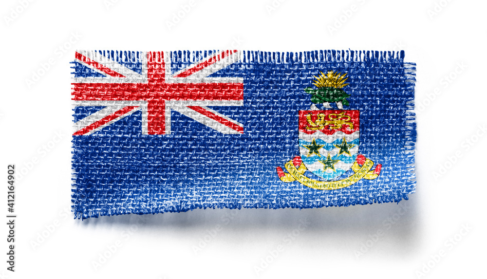 Cayman Islands flag on a piece of cloth on a white background