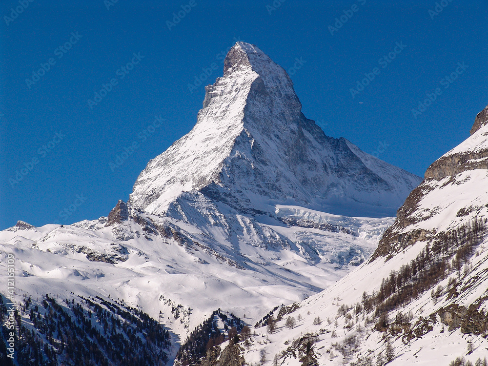 The immaculate peak of the Matterhorn rises above the village of Zermatt in the Swiss Alps. Thousands of mountaineers, skiers and tourists admire it every day.