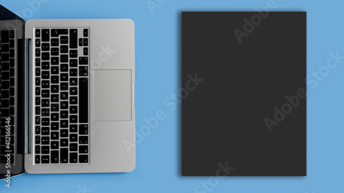 Dark blank sheet. Laptop on a blue background.