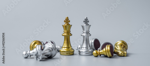 gold Chess king figure stand out from crowd of enermy or opponent during chessboard competition. Strategy, Success, management, business planning, disruption, win and leadership concept photo