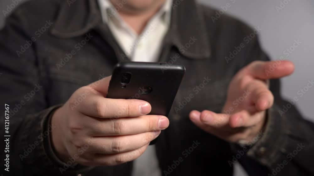 A Man Does His Small Business From A Smartphone. Problems of the Beginner Businessman. A Man Does His Small Business From A Smartphone. Problems of the Beginner Businessman.