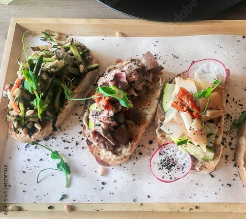 Bruschetta with tomatoes, made dish on a cutting board. Traditional italian appetizer or snack, antipasto. Top view. Flat lay
