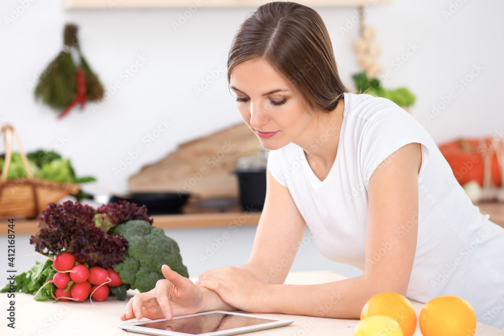 Young woman is making online shopping by tablet computer and credit card Young woman is making online shopping by tablet computer and credit card
