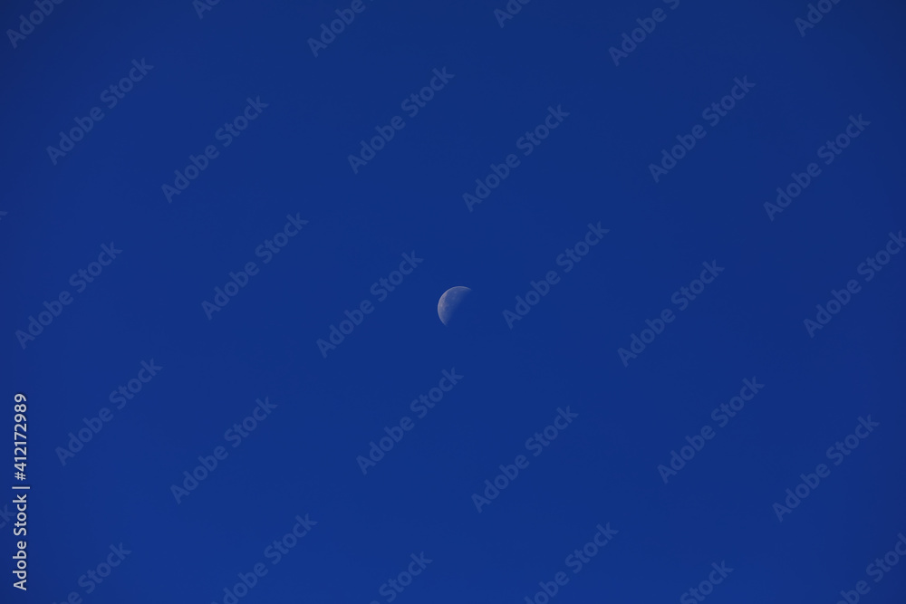 The moon in the blue sky during the day The moon in the blue sky during the day
