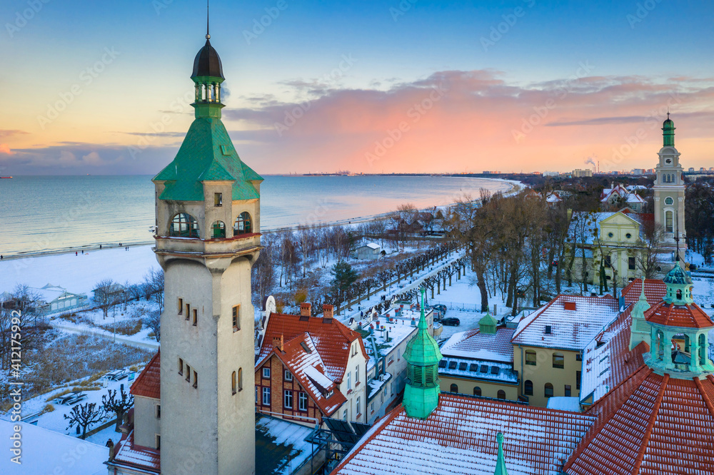 Fototapeta premium Beautiful sunset over the snowy beach and pier (Molo) in Sopot at winter. Poland