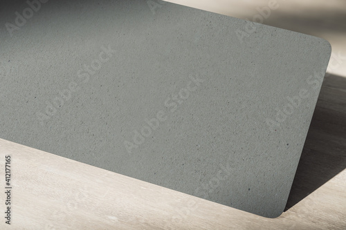 Blank black paper texture of giftcard at abstract wooden background. Eco friendly paper concept. Mockup. 3D rendering