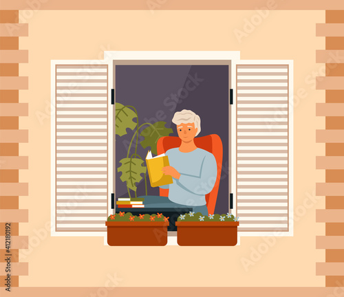 Man is reading book on balcony of his house. Young guy sits in armchair and looks out the window. Male character resting at home. Citizen stays at home, daily life routine, hobby time relaxing