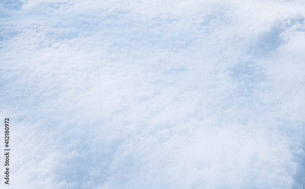 Snow texture. Top view of the white snow. Background with copy space. Winter time
