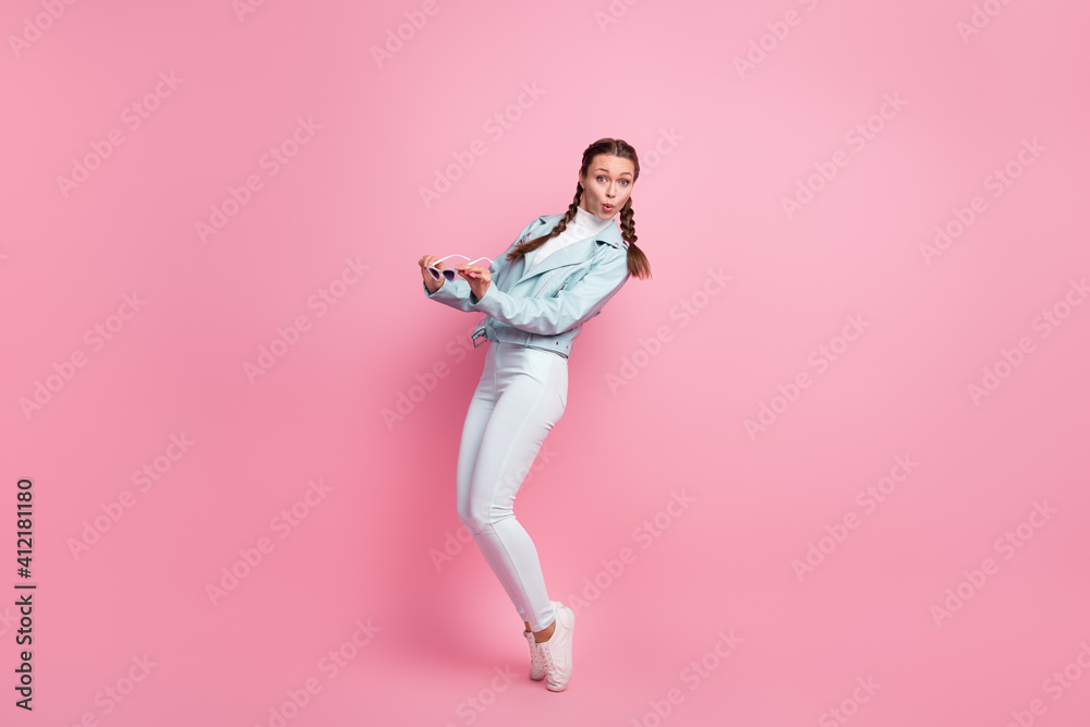Full body profile side photo of young attractive girl amazed surprised isolated over pink color background Full body profile side photo of young attractive girl amazed surprised isolated over pink color background