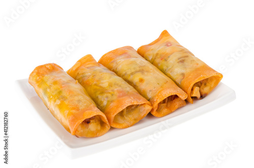 Spring rolls with chicken and vegetables on white plate